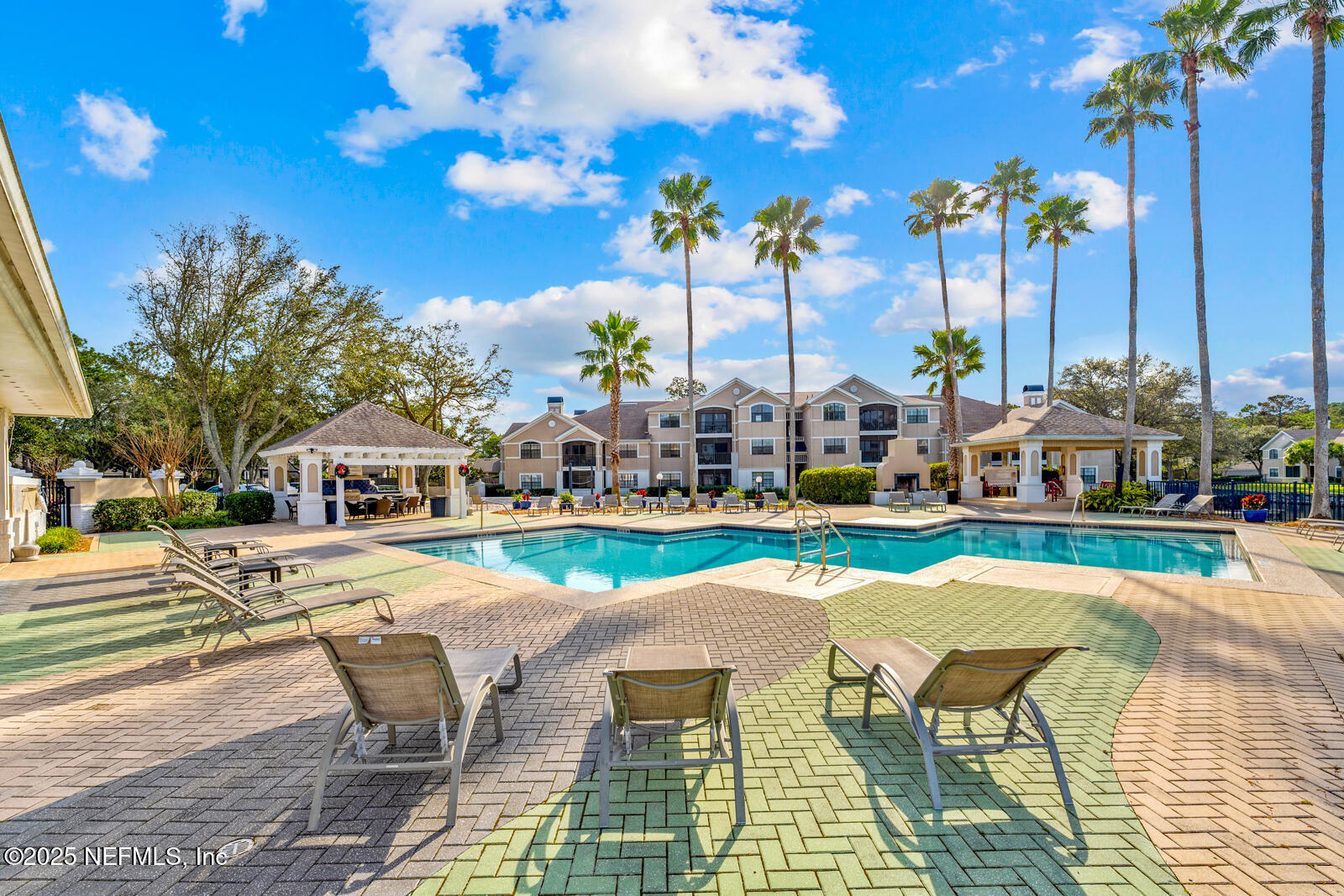 425 Timberwalk Court, Unit 1112 Ponte Vedra Beach, FL 32082 - Photo 54 of 66 a view of a swimming pool with lawn chairs and a barbeque with potted plants