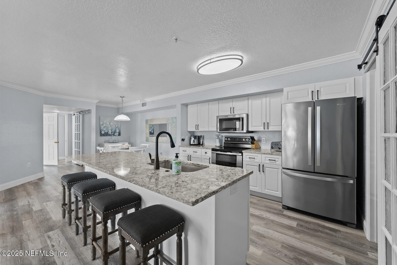 425 Timberwalk Court, Unit 1112 Ponte Vedra Beach, FL 32082 - Photo 8 of 66 a kitchen with refrigerator cabinets dining table and chairs