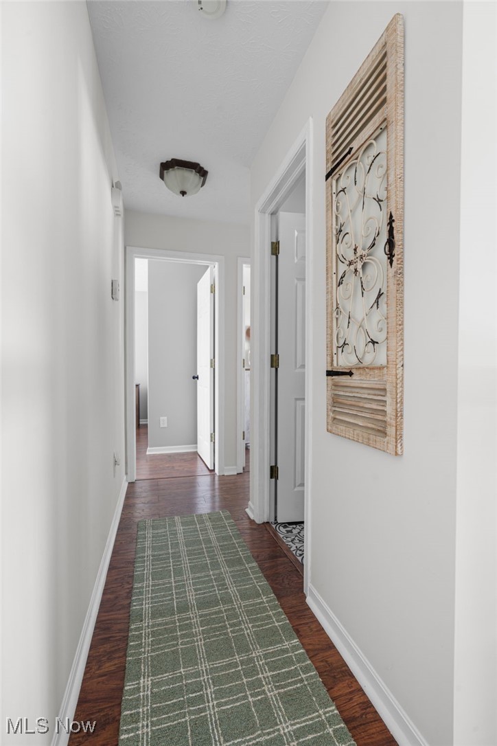 64 River Ridge Lane Munroe Falls, OH 44262 - Photo 11 of 25 Corridor featuring dark wood finished floors