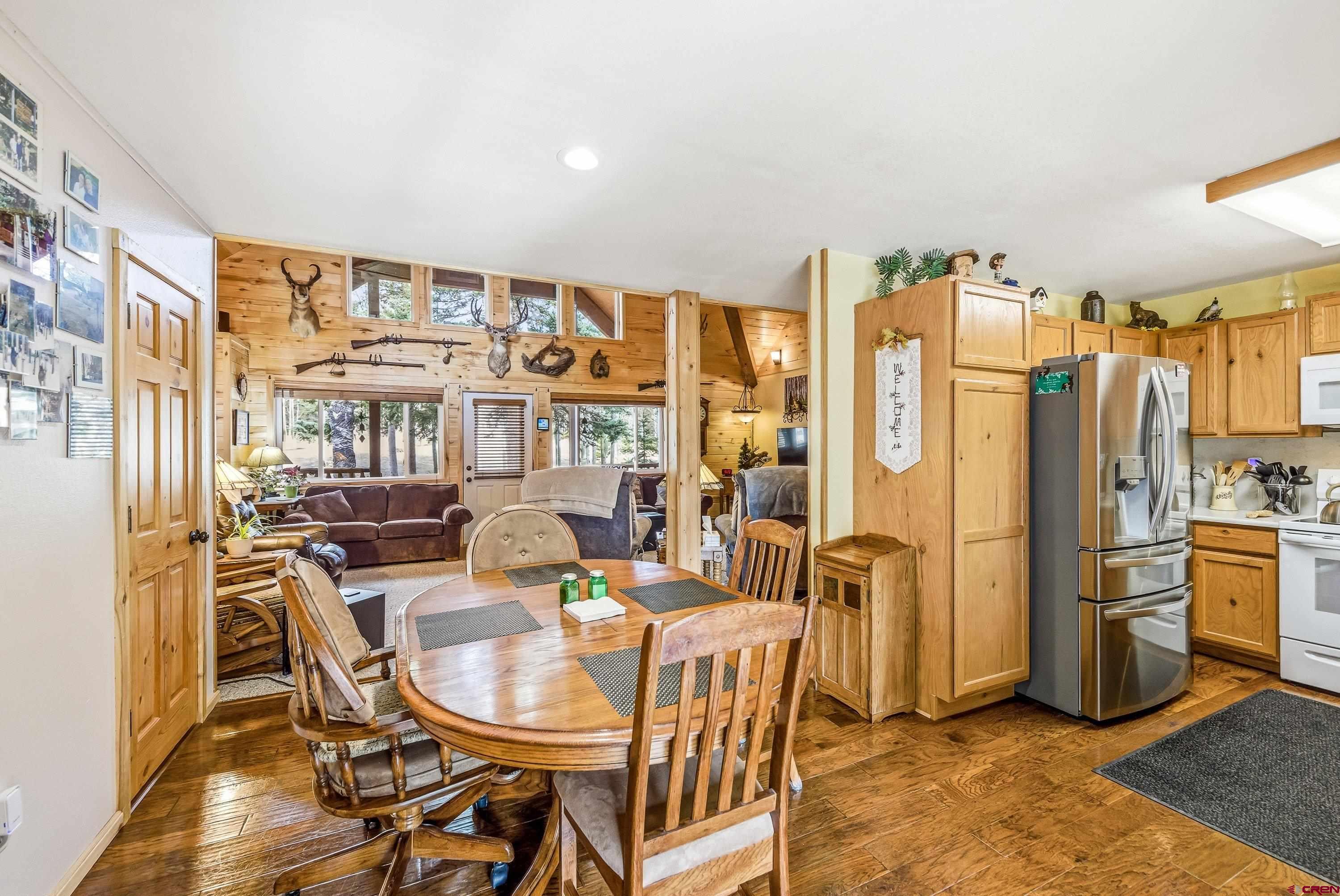 200 Lake Road Cimarron, CO 81220 - Photo 12 of 45 a dining room with furniture a large window and stainless steel appliances