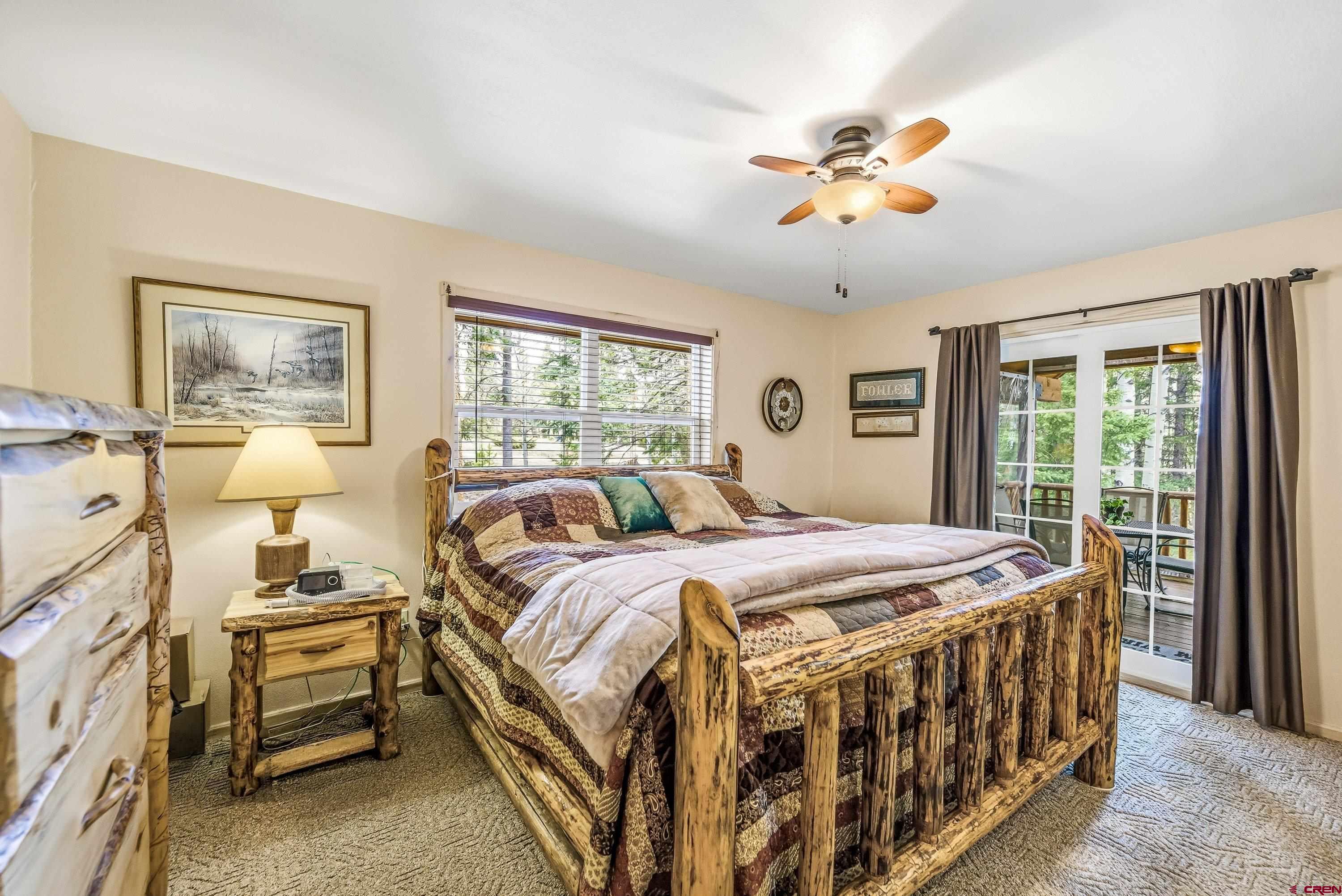 200 Lake Road Cimarron, CO 81220 - Photo 13 of 45 a bed room with a bed and a chandelier