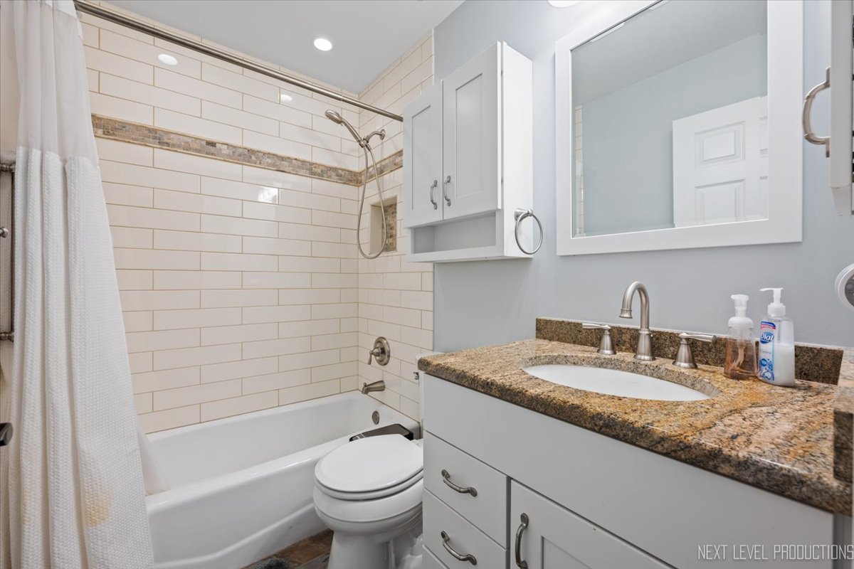 2167 Countryside Circle Naperville, IL 60565 - Photo 15 of 27 a bathroom with a granite countertop sink toilet and shower