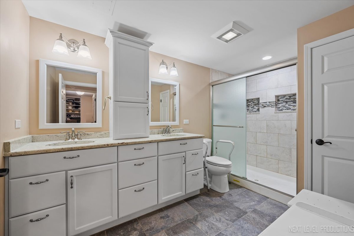 2167 Countryside Circle Naperville, IL 60565 - Photo 22 of 27 a bathroom with a double vanity sink toilet and shower