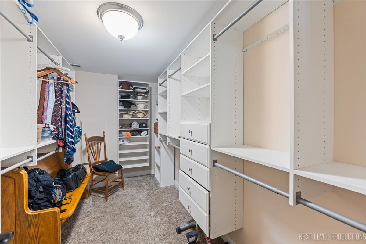 2167 Countryside Circle Naperville, IL 60565 - Photo 23 of 27 a view of walk in closet with clothes and shoes