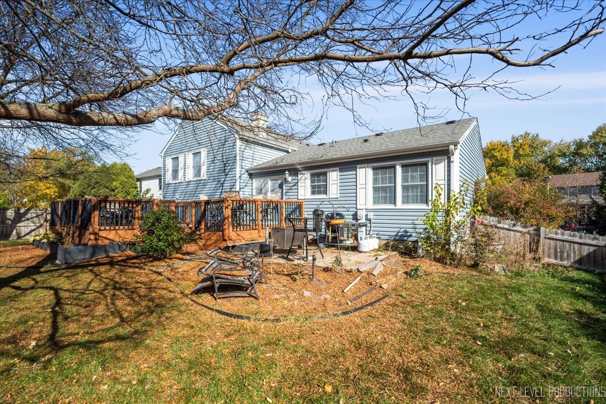 2167 Countryside Circle Naperville, IL 60565 - Photo 25 of 27 a view of a patio with table and chairs with wooden fence and plants