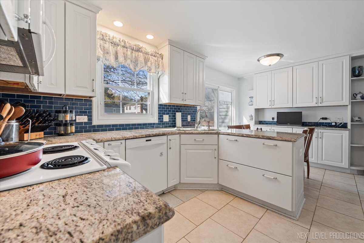 2167 Countryside Circle Naperville, IL 60565 - Photo 3 of 27 a kitchen with white cabinets and appliances