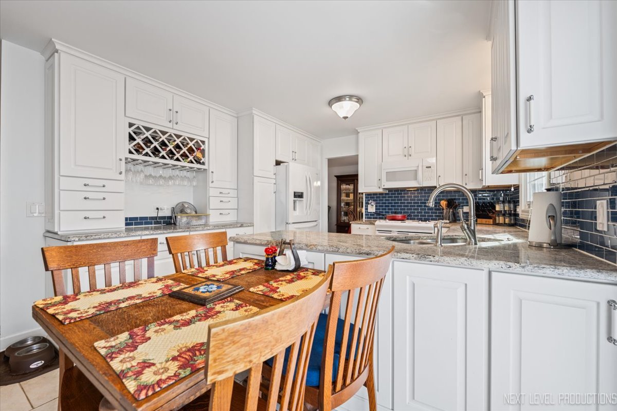2167 Countryside Circle Naperville, IL 60565 - Photo 4 of 27 a kitchen with stainless steel appliances granite countertop a stove a sink and a refrigerator