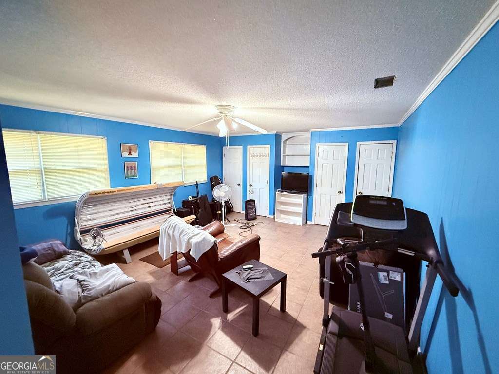 1881 Bell Telephone Road Hazlehurst, GA 31539 - Photo 14 of 71 a living room with furniture a flat screen tv and a window