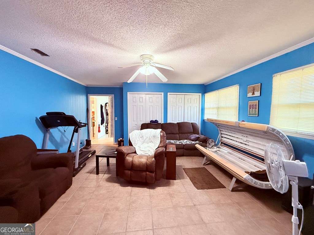 1881 Bell Telephone Road Hazlehurst, GA 31539 - Photo 15 of 71 a living room with furniture a ceiling fan and a window