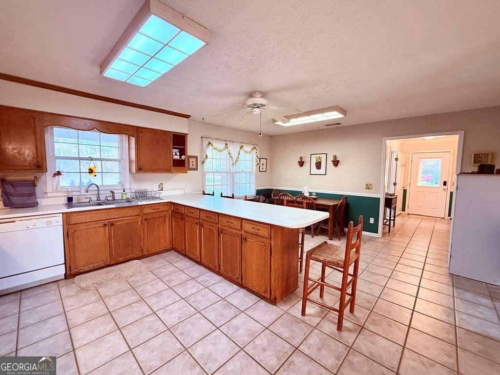 1881 Bell Telephone Road Hazlehurst, GA 31539 - Photo 19 of 71 a kitchen with stainless steel appliances kitchen island granite countertop a sink and cabinets
