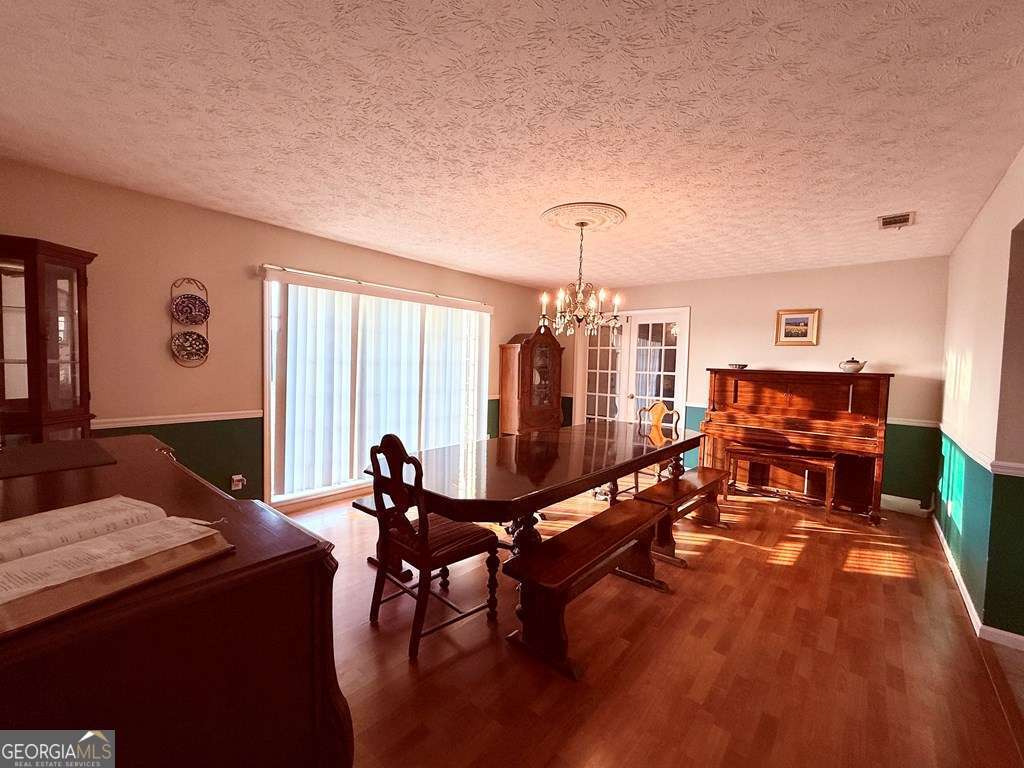 1881 Bell Telephone Road Hazlehurst, GA 31539 - Photo 22 of 71 a living room with furniture a rug and a chandelier