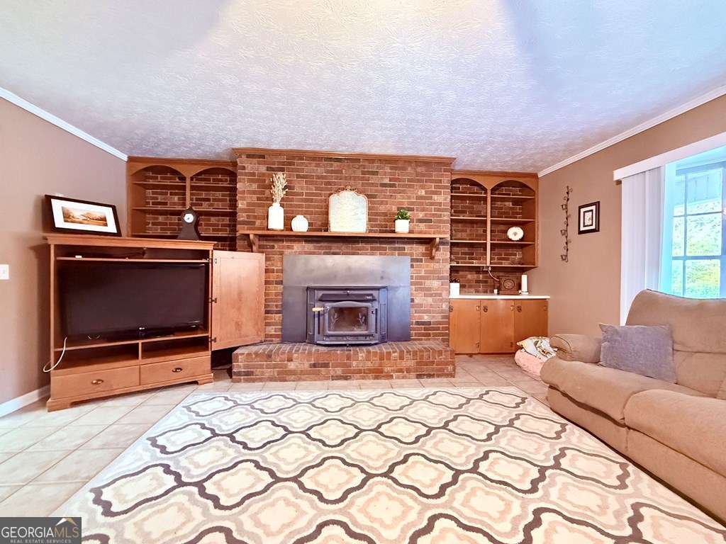 1881 Bell Telephone Road Hazlehurst, GA 31539 - Photo 28 of 71 a living room with furniture and a fireplace