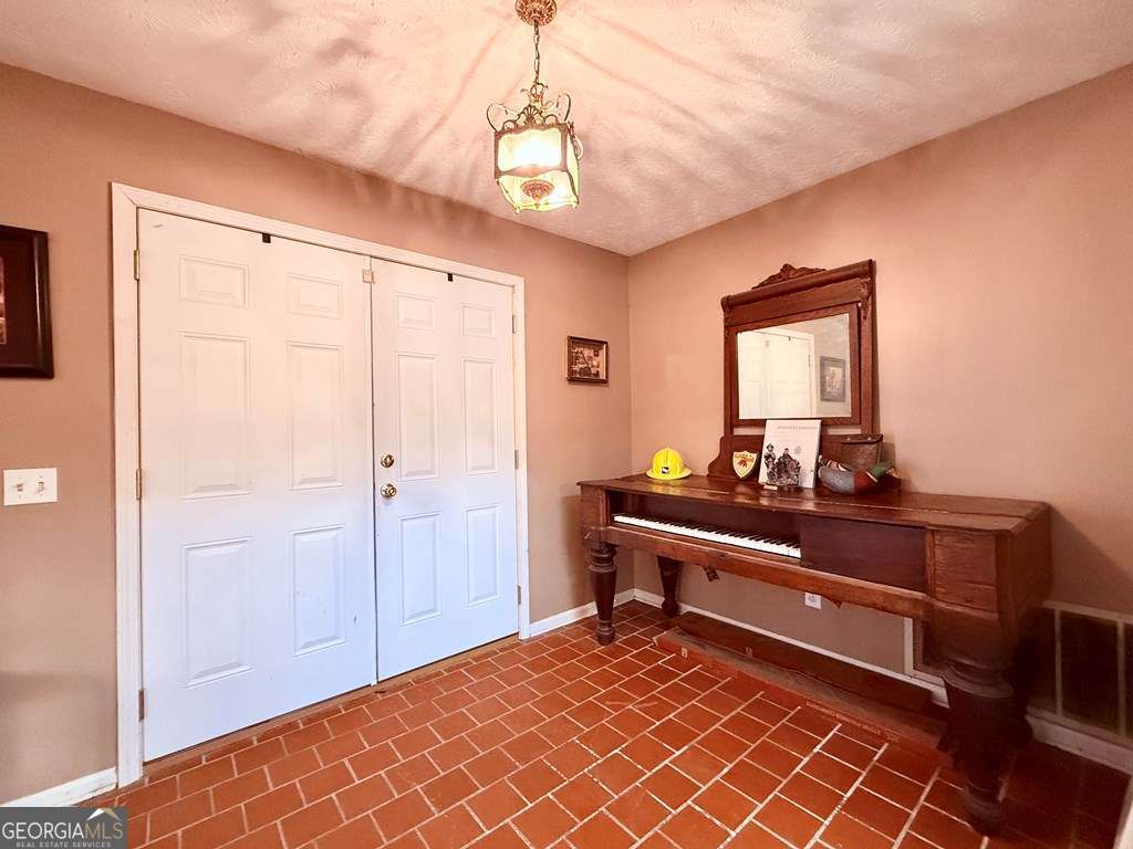 1881 Bell Telephone Road Hazlehurst, GA 31539 - Photo 29 of 71 a room with a bed and a dresser