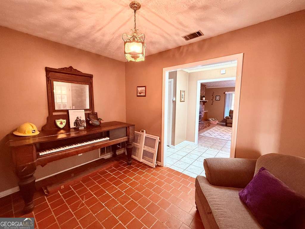 1881 Bell Telephone Road Hazlehurst, GA 31539 - Photo 30 of 71 a bedroom with furniture and a chandelier