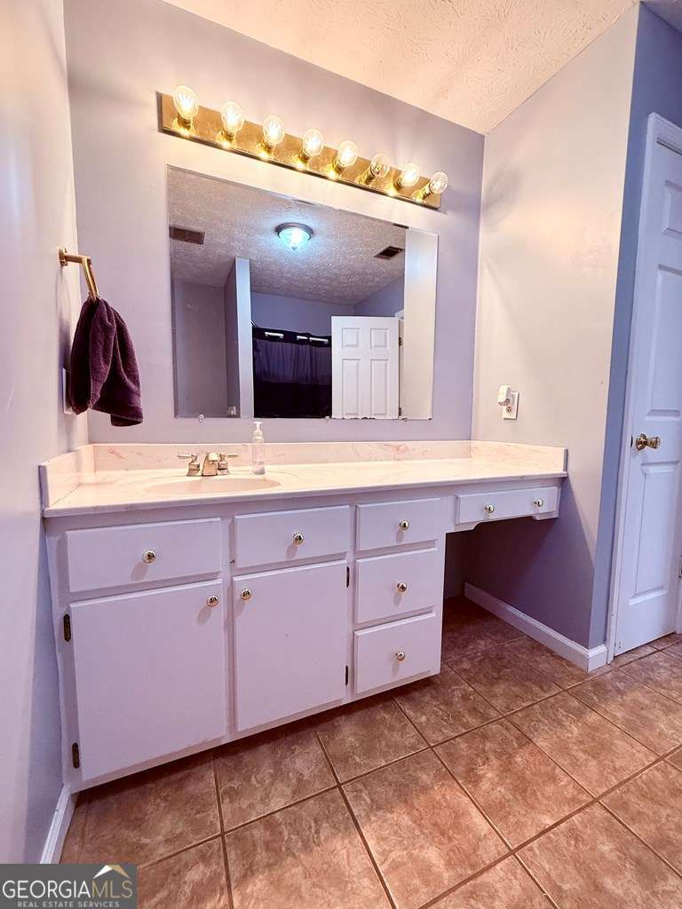 1881 Bell Telephone Road Hazlehurst, GA 31539 - Photo 32 of 71 a bathroom with a sink and a mirror