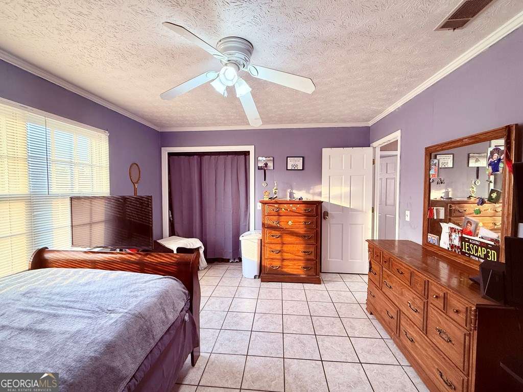 1881 Bell Telephone Road Hazlehurst, GA 31539 - Photo 35 of 71 a bedroom with a bed and a dresser