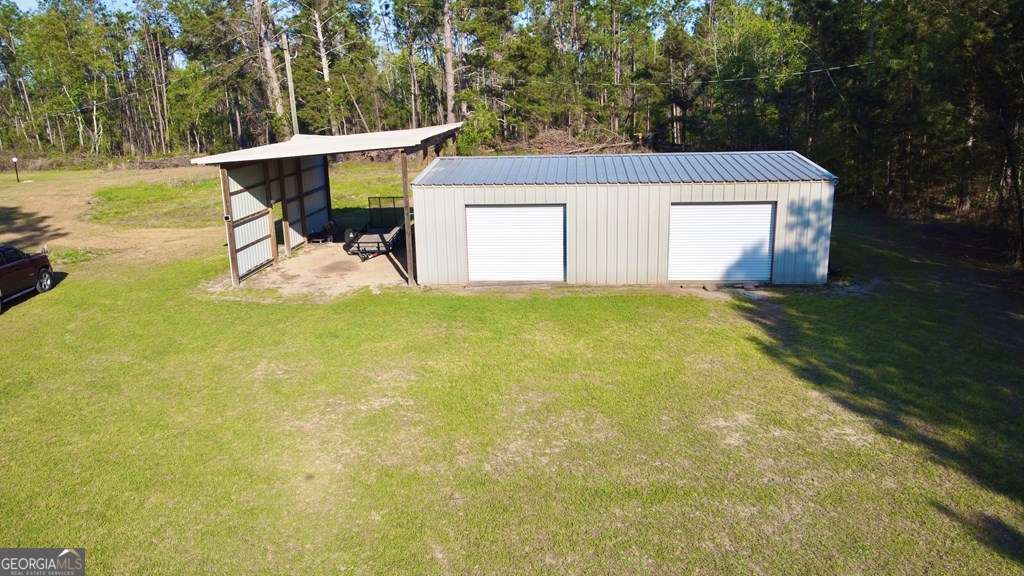 1881 Bell Telephone Road Hazlehurst, GA 31539 - Photo 7 of 71 a view of a swimming pool with a patio and a yard