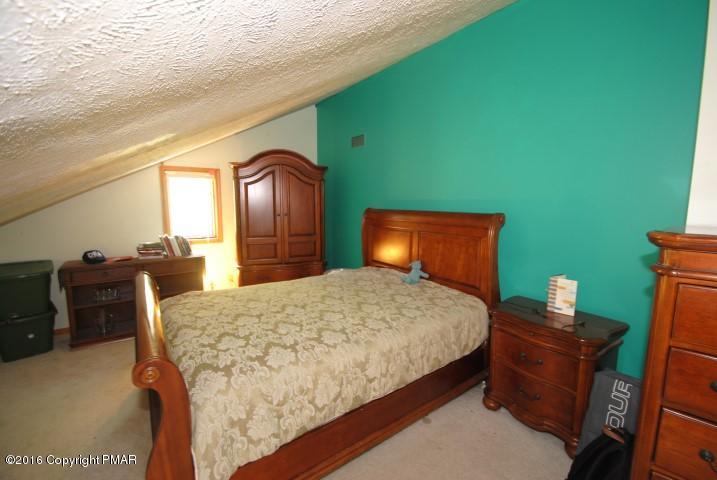 154 Bowman Road Mount Pocono, PA 18344 - Photo 28 of 41 a bedroom with a bed and a dresser