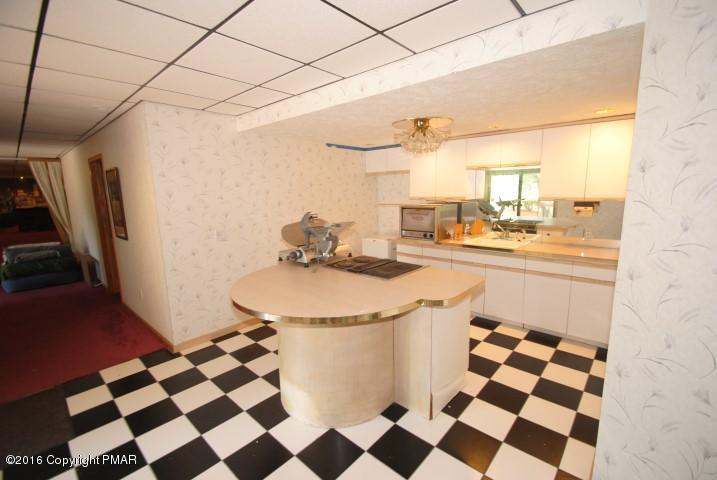 154 Bowman Road Mount Pocono, PA 18344 - Photo 31 of 41 a kitchen with a sink a stove and a refrigerator
