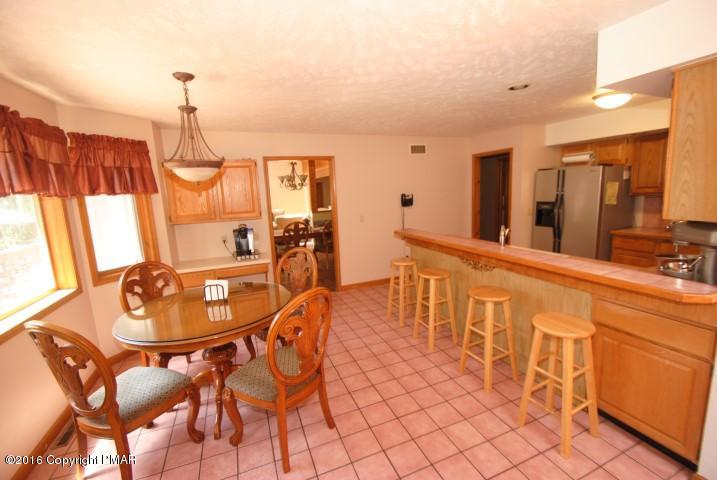 154 Bowman Road Mount Pocono, PA 18344 - Photo 8 of 41 a dining room with furniture a chandelier and wooden floor