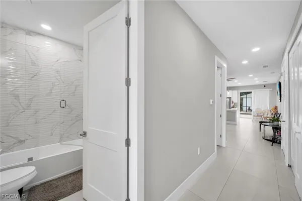 a view of a livingroom with a ceiling fan & entryway