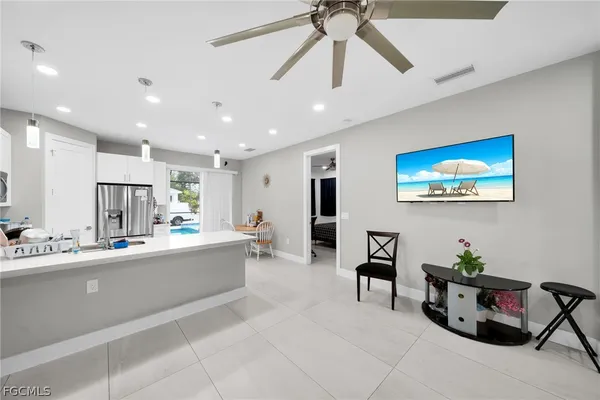 a large white kitchen with lots of counter space and dining table