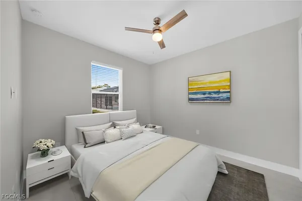 a bedroom with a large bed and a potted plant