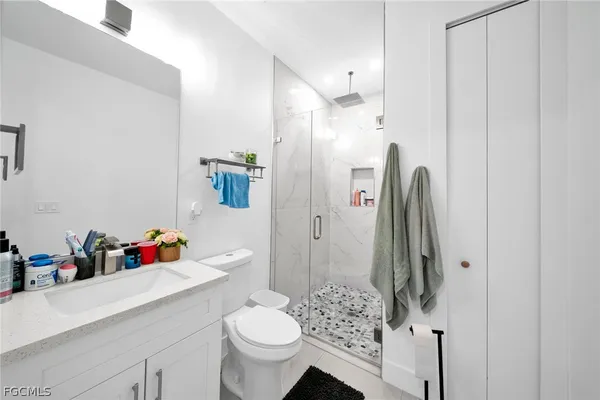 a bathroom with a sink toilet and shower
