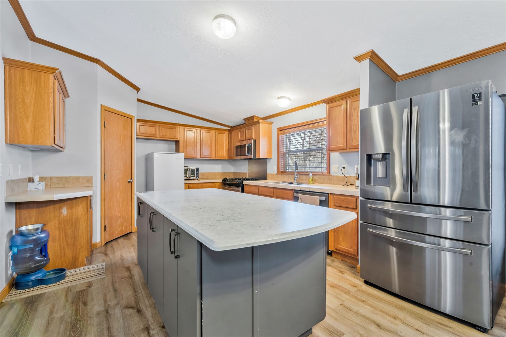 366 South 2nd Street Hayden, CO 81639 - Photo 11 of 38 a kitchen with kitchen island a counter top space a sink refrigerator and cabinets