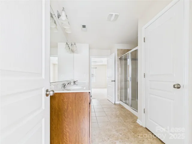 a spacious bathroom with a tub shower and a sink