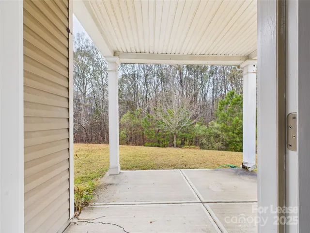 a view of a room with a window and front door