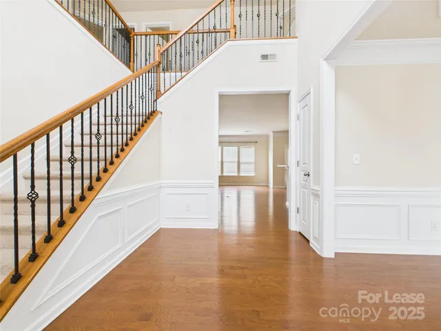 a view of staircase with white walls and next to a window