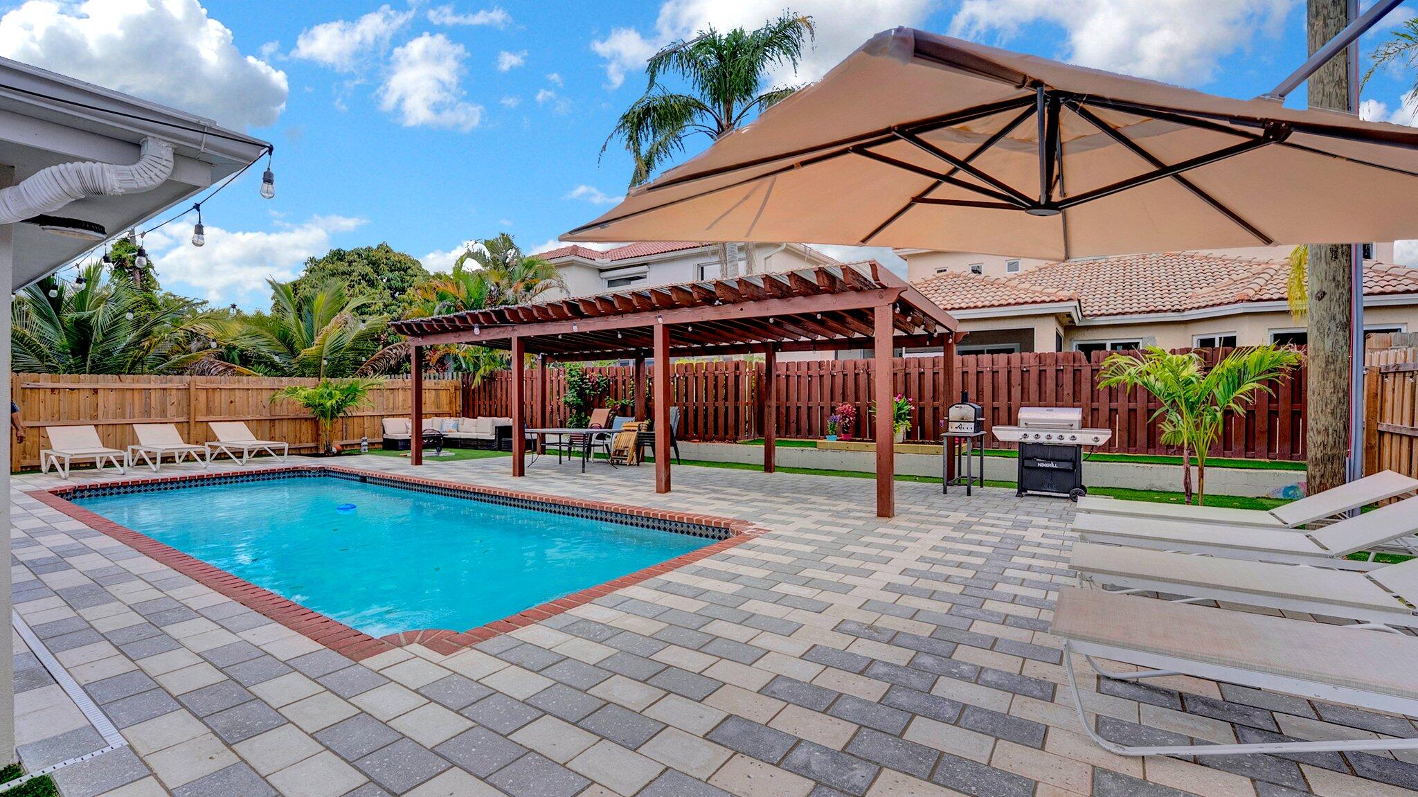 9709 Southwest 1st Place Boca Raton, FL 33428 - Photo 20 of 32 a view of a swimming pool with a patio