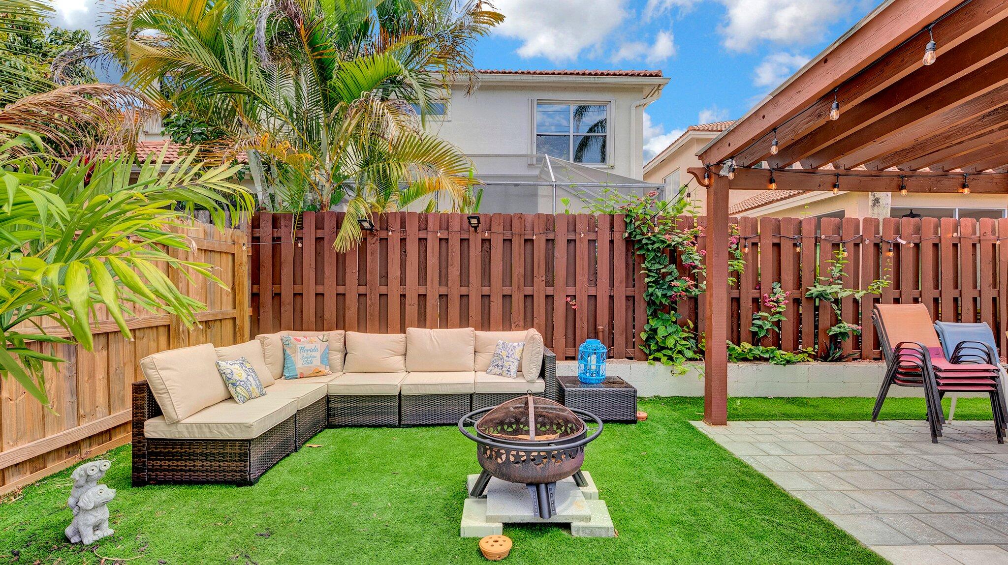 9709 Southwest 1st Place Boca Raton, FL 33428 - Photo 24 of 32 a view of a patio with a table and chairs