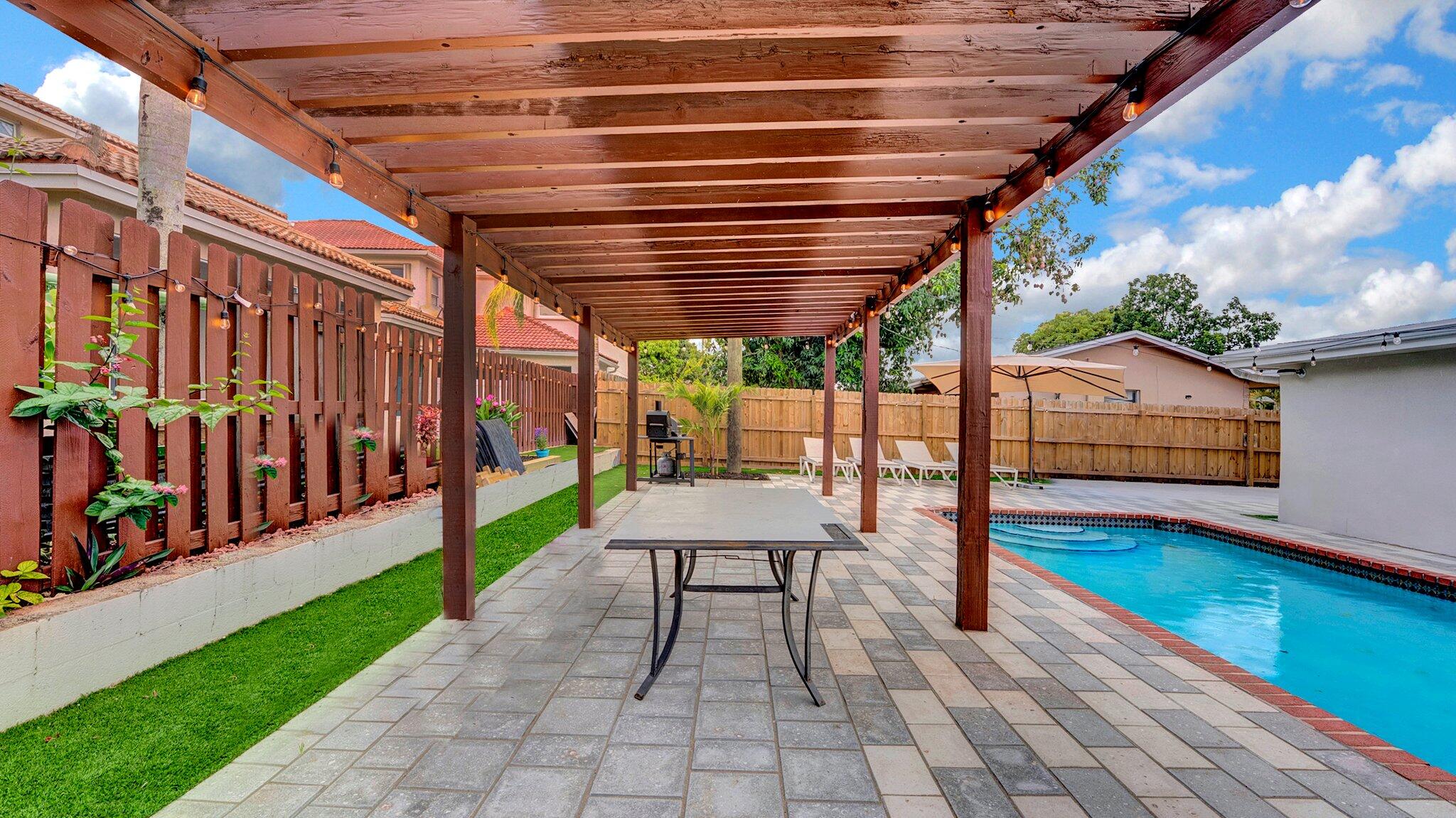 9709 Southwest 1st Place Boca Raton, FL 33428 - Photo 25 of 32 a view of a patio with wooden floor