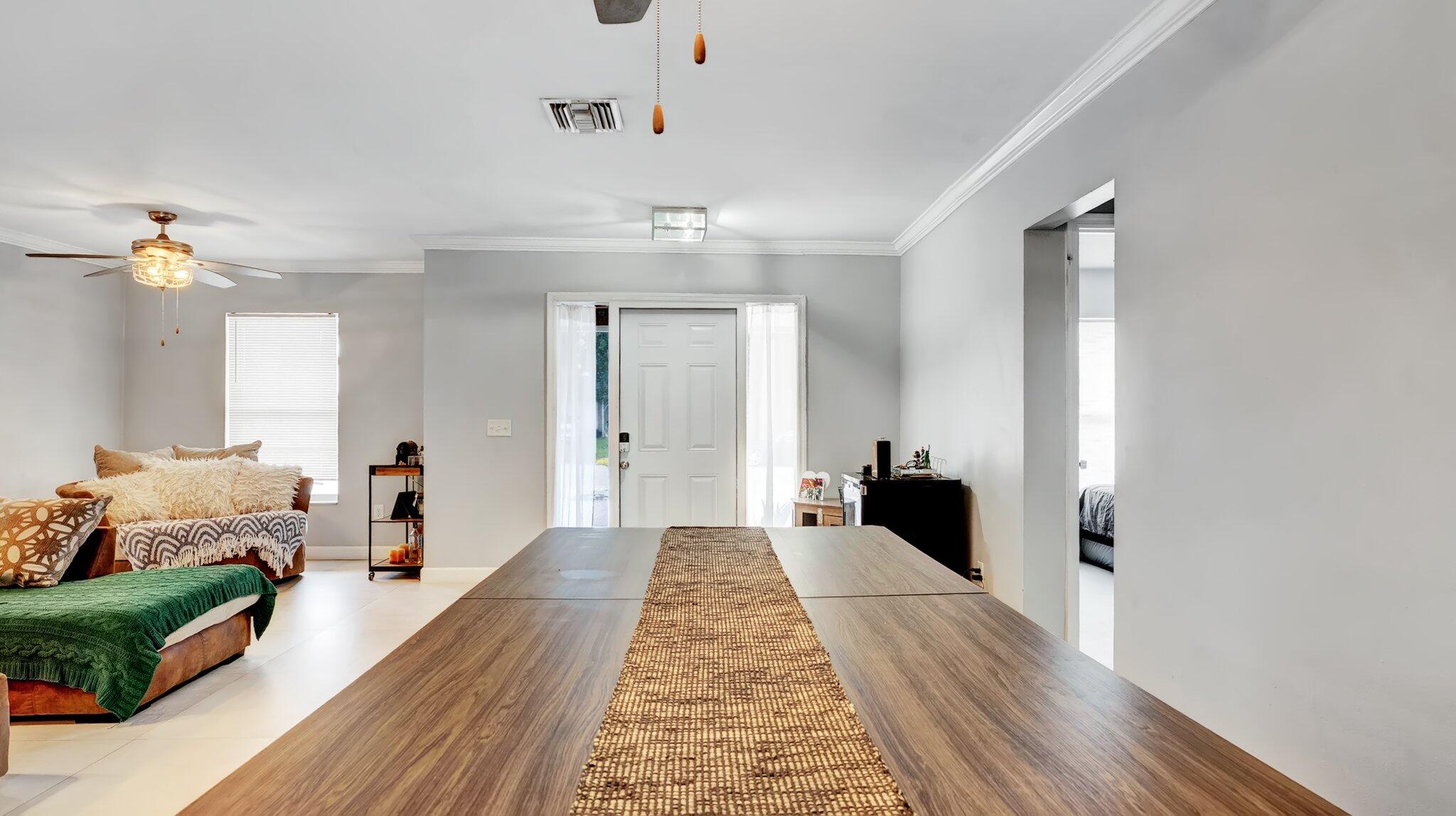 9709 Southwest 1st Place Boca Raton, FL 33428 - Photo 8 of 32 a living room with furniture and a chandelier