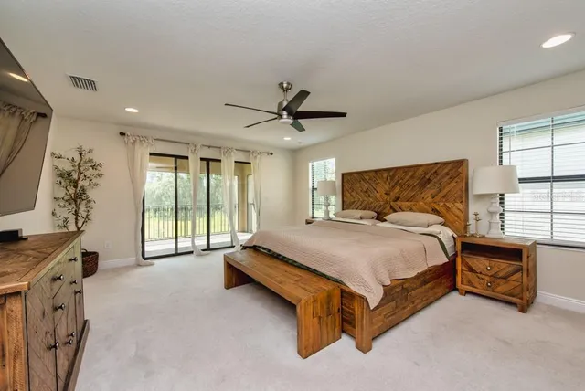 a bedroom with a bed and a chandelier