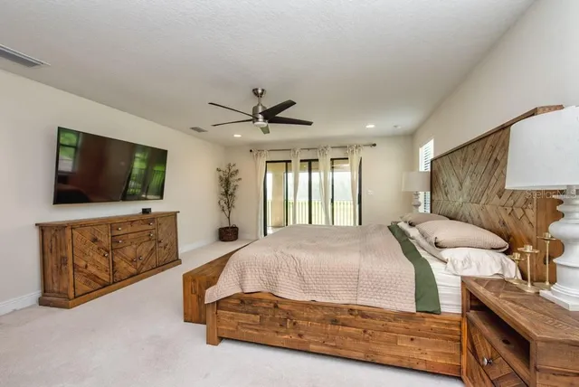 a large bathroom with a granite countertop double vanity sink a mirror and a bathtub