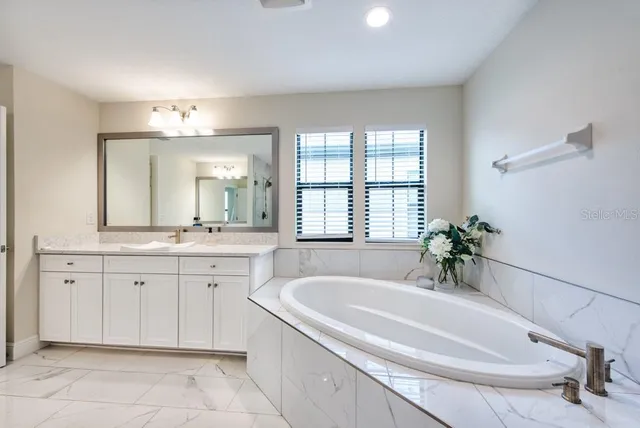 a bathroom with a granite countertop sink a shower and a mirror