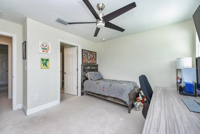 a bathroom with a granite countertop sink a large mirror and a bathtub