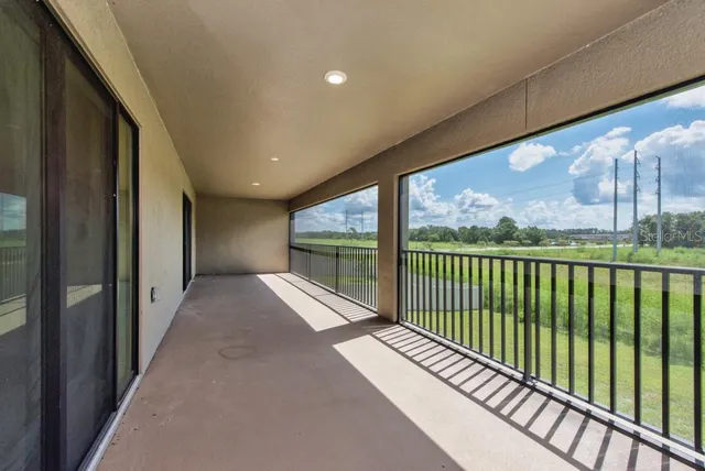 a very nice looking yard with a large window and potted plants