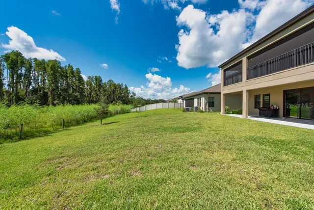a view of a house with a garden and yard
