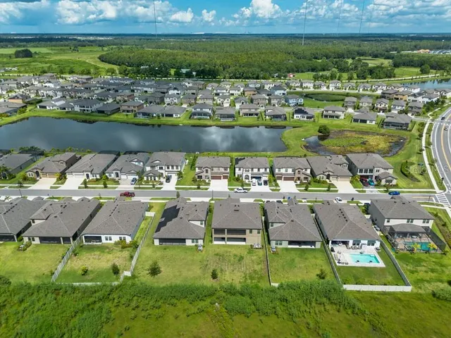 an aerial view of a house with a yard
