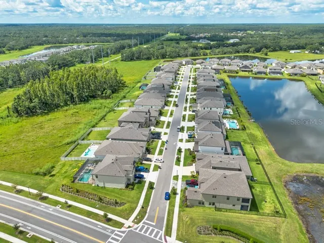 a aerial view of a house with swimming pool and ocean view