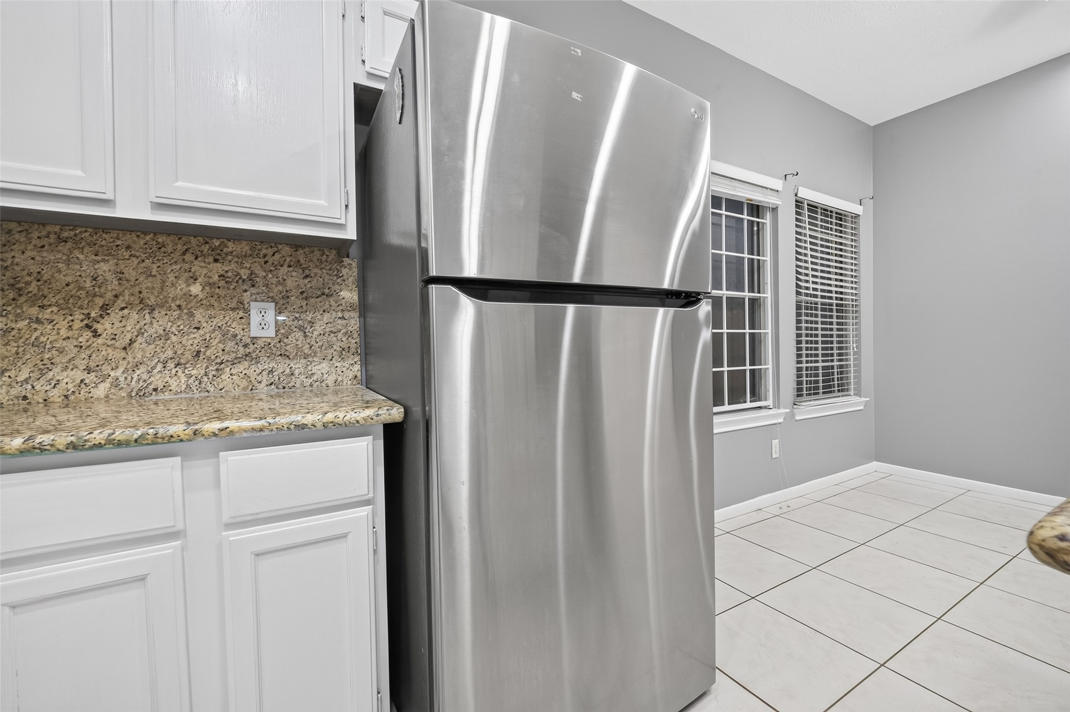 13607 Sable Lane Houston, TX 77014 - Photo 19 of 46 a bathroom with a granite countertop sink and a refrigerator
