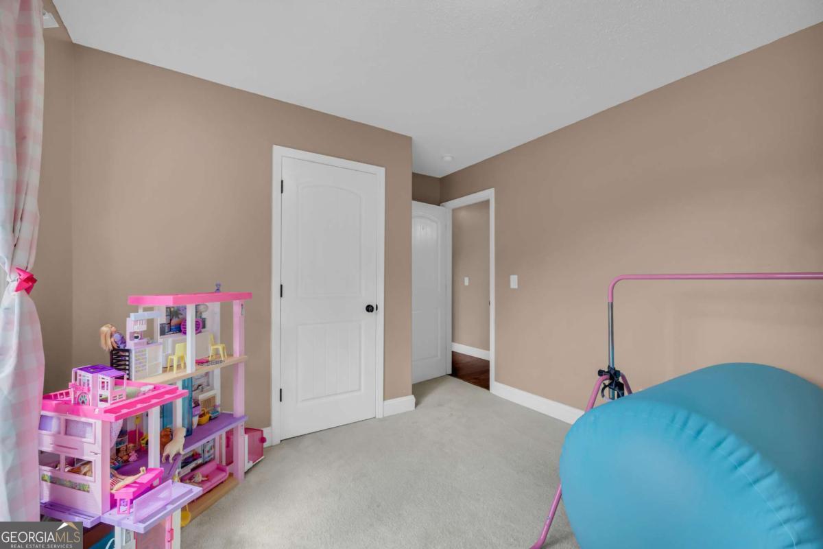 335 Elizabeth Court Colbert, GA 30628 - Photo 15 of 33 a bedroom with furniture and a chandelier