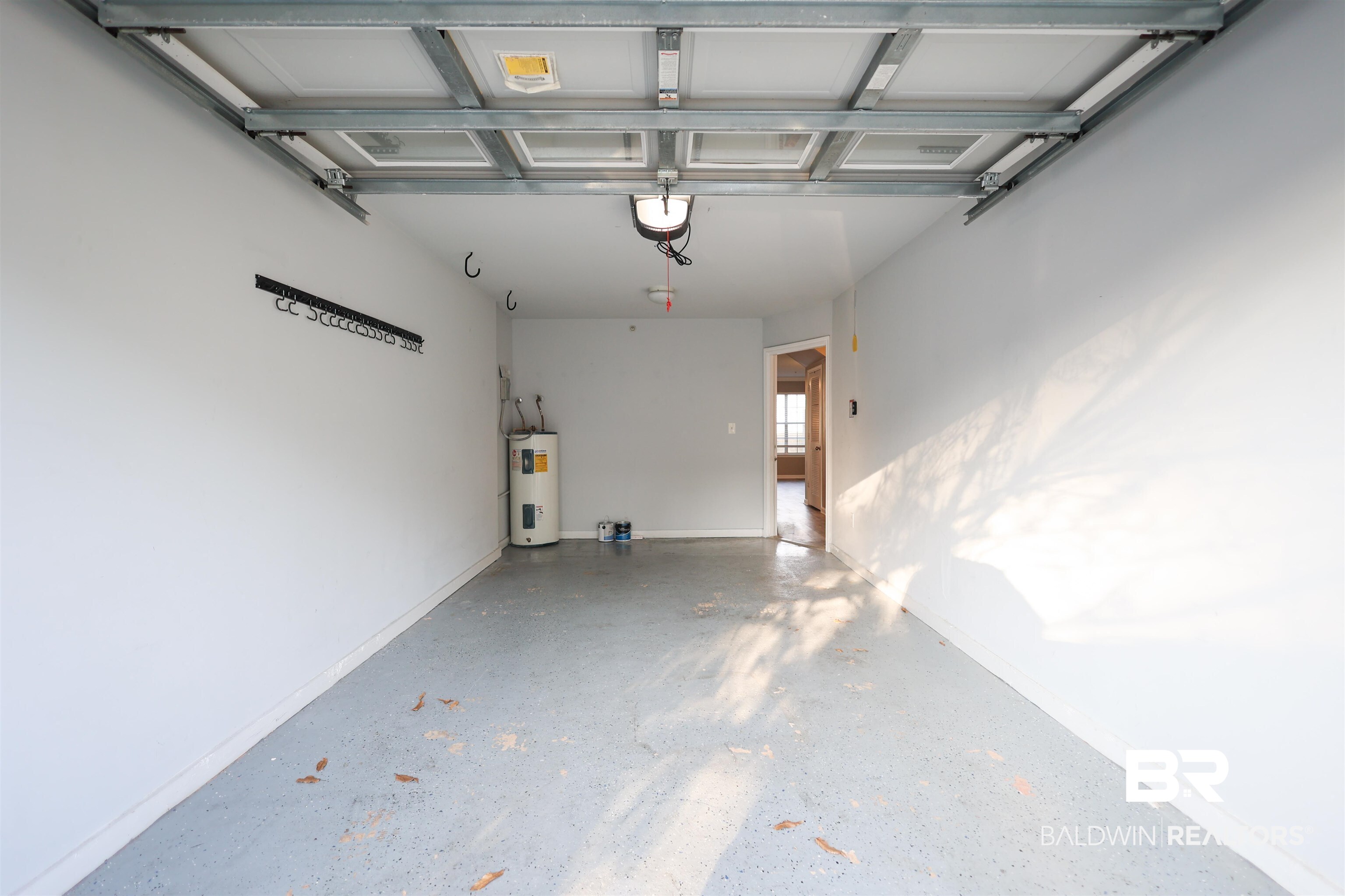 1517 Regency Road, Unit 125 Gulf Shores, AL 36542 - Photo 25 of 26 Garage with water heater and baseboards