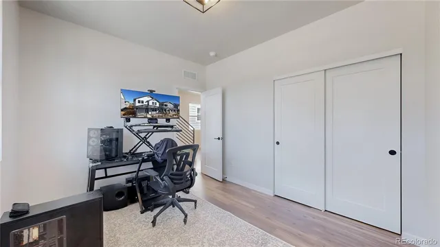 a bedroom with a bed and a painting on the wall