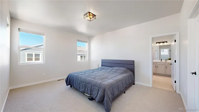 a bedroom with a bed and painting on the wall