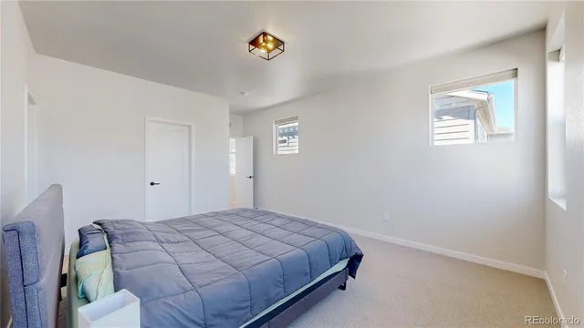 a spacious en suite bathroom with a double sink tub and mirror